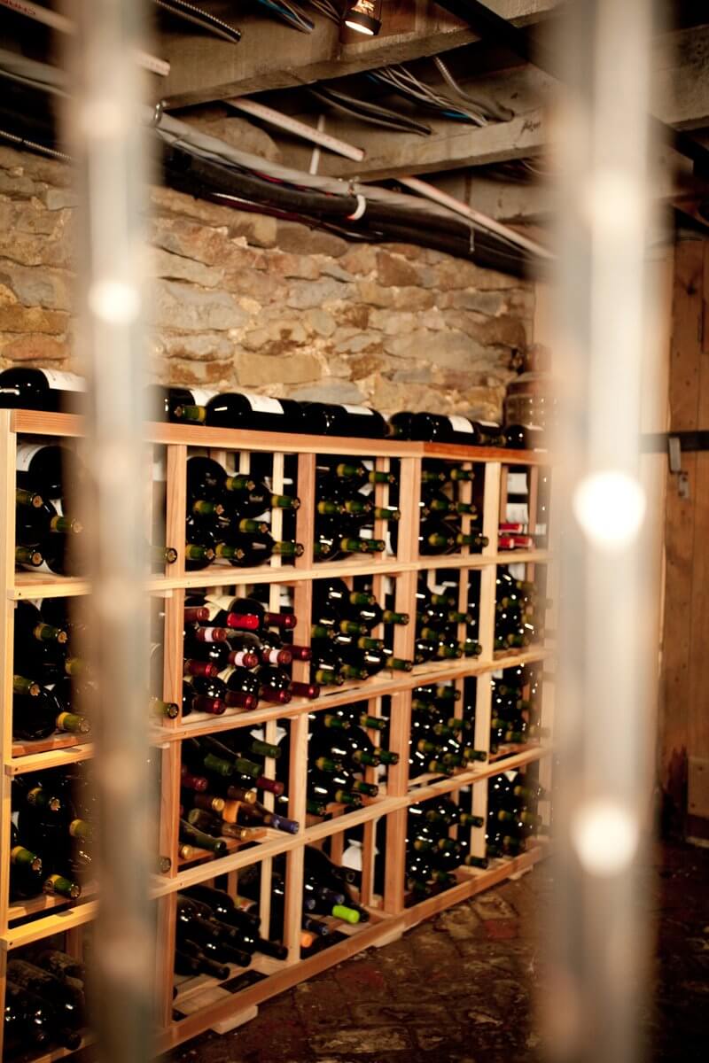 A wine cellar with many bottles of wine.