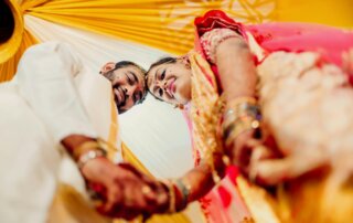 An Indian couple taking part in a mulit-day wedding celebration.