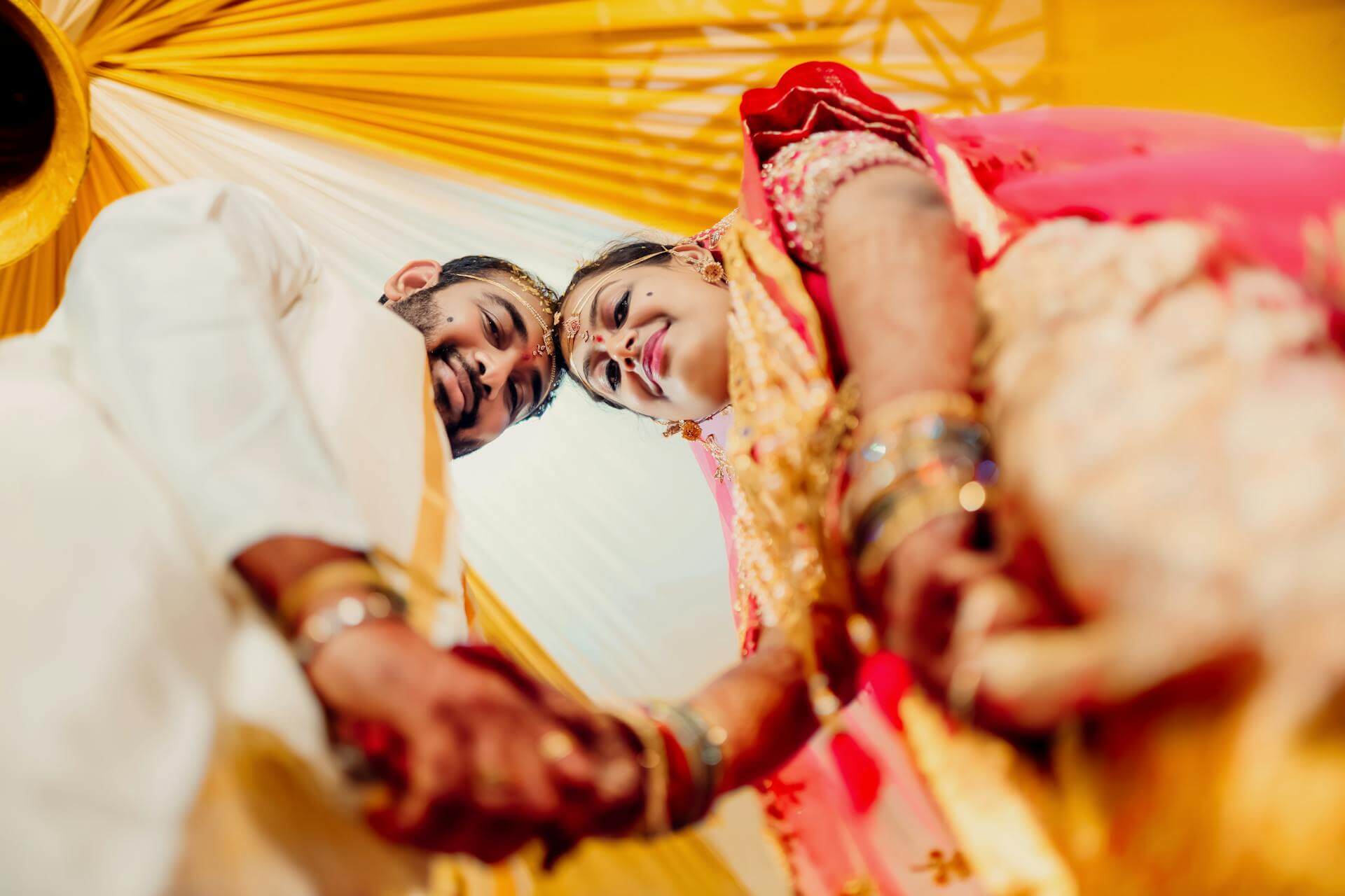 An Indian couple taking part in a mulit-day wedding celebration.